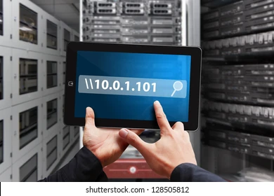 A hand holding a tablet displaying an IP address